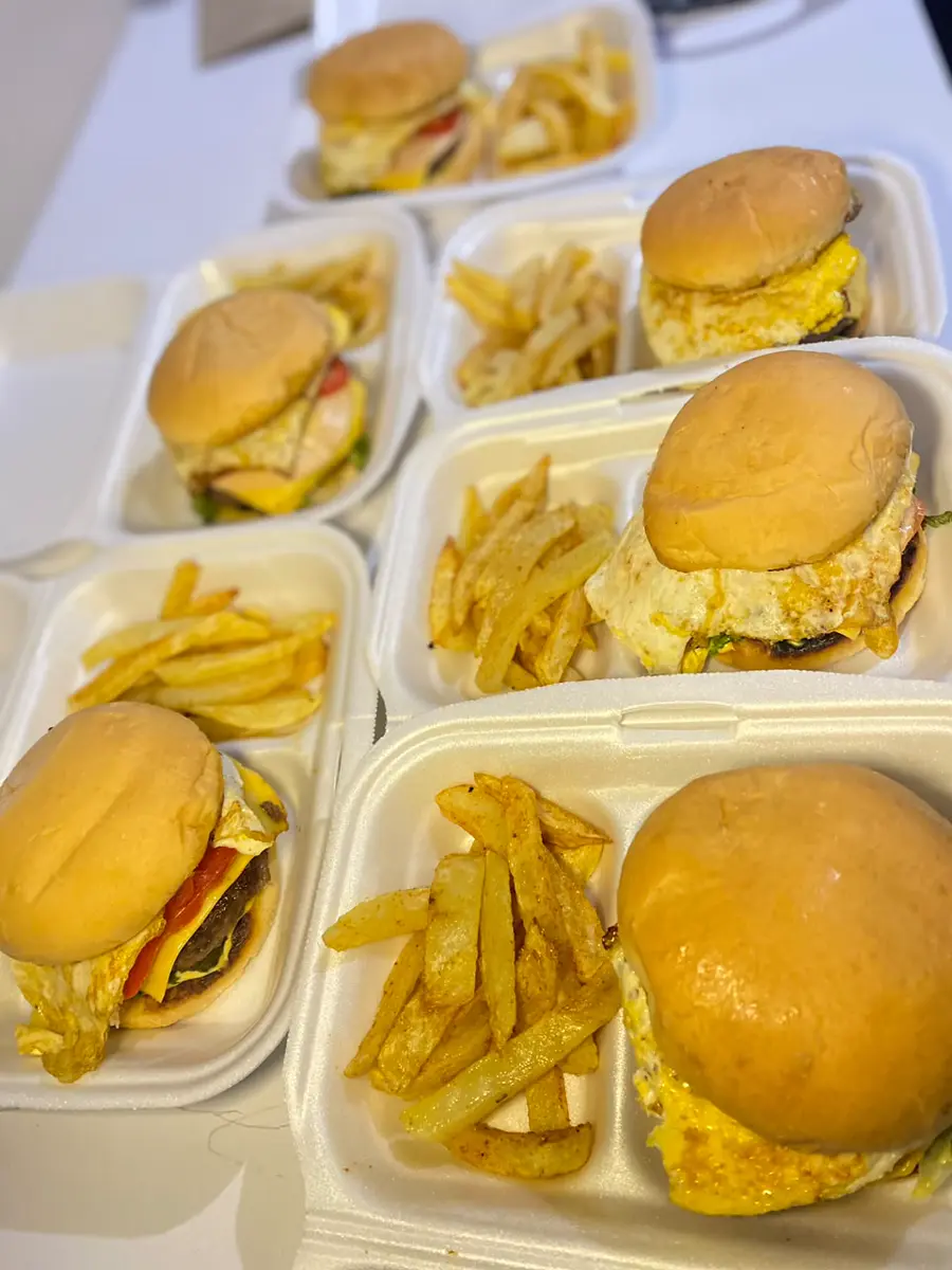 Cheeseburgers and fries in takeaway containers
